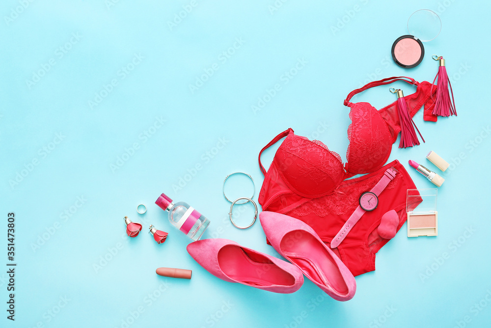 Female accessories and underwear on color background