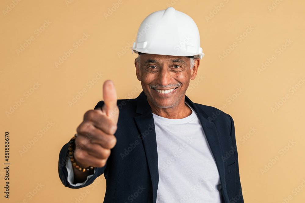 Mixed Indian engineer doing a thumbs up hand gesture