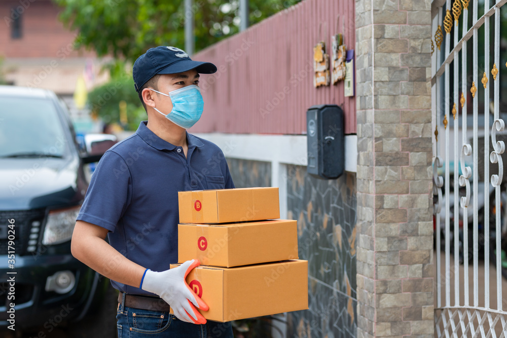 Delivery asian man holding cardboard boxes in medical rubber gloves and mask. Online shopping and Ex