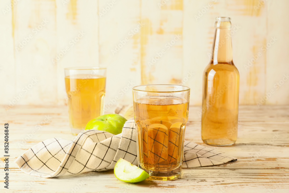 Glassware of fresh apple cider on table