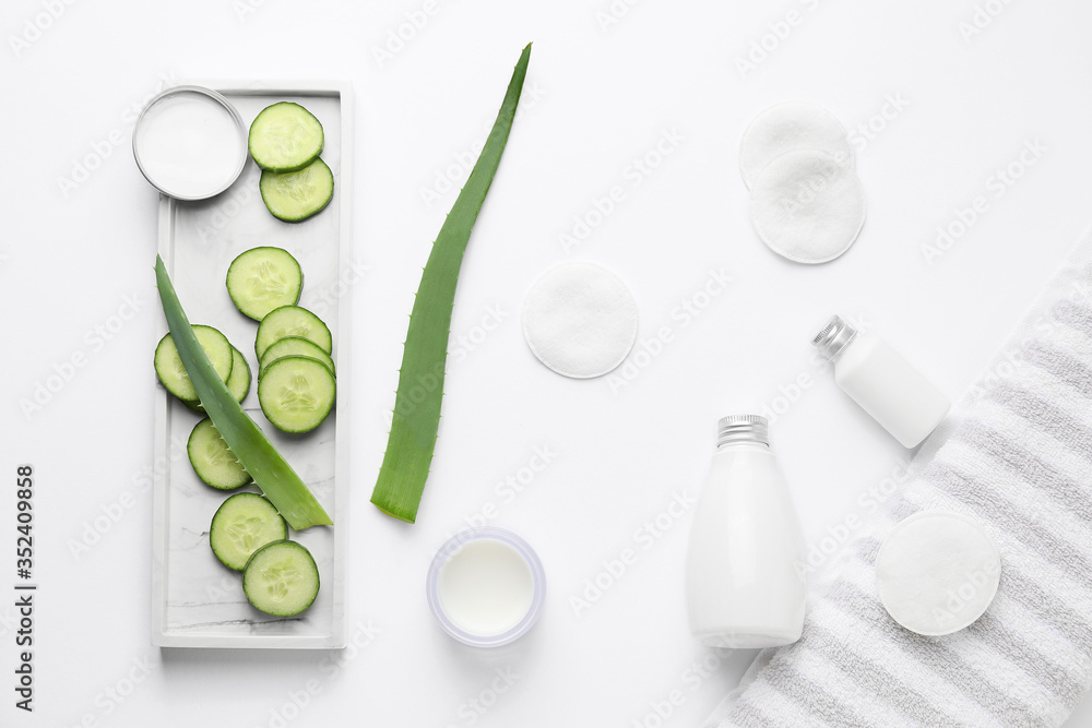 Composition with cucumber and cosmetics on white background