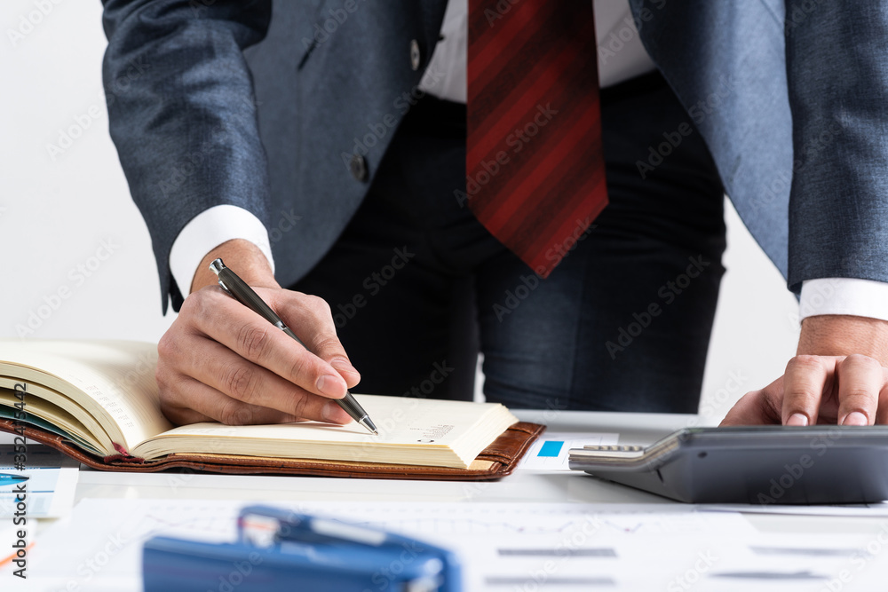 Close-up businessman hand writing to do list