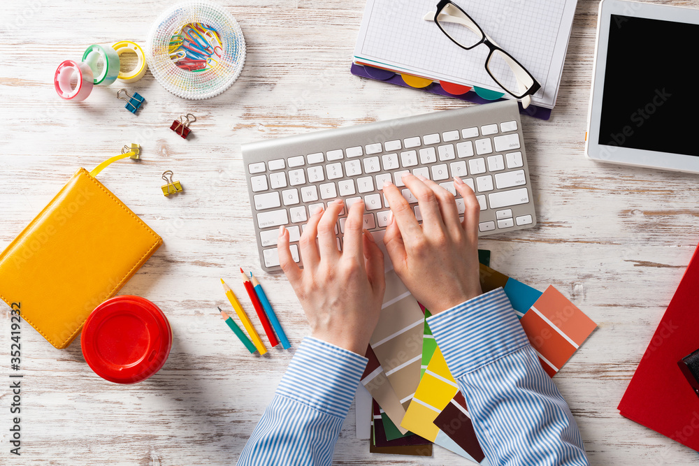 Woman designer typing on keyboard