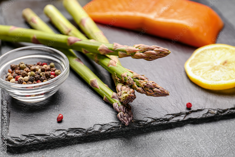 Asparagus with spices on dark background