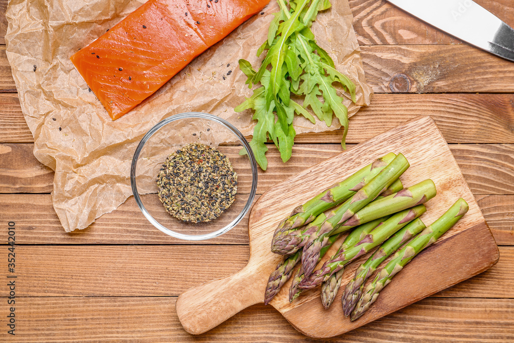 Asparagus with salmon and spices on table