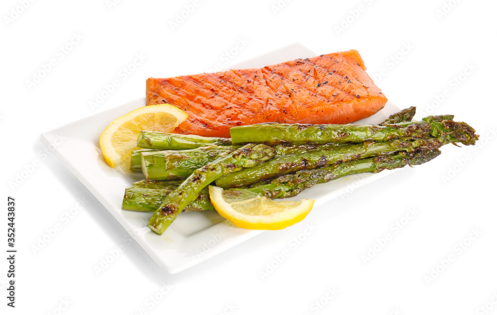 Cooked asparagus with salmon and lemon on white background