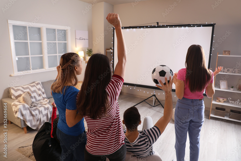 Young friends watching sports at home