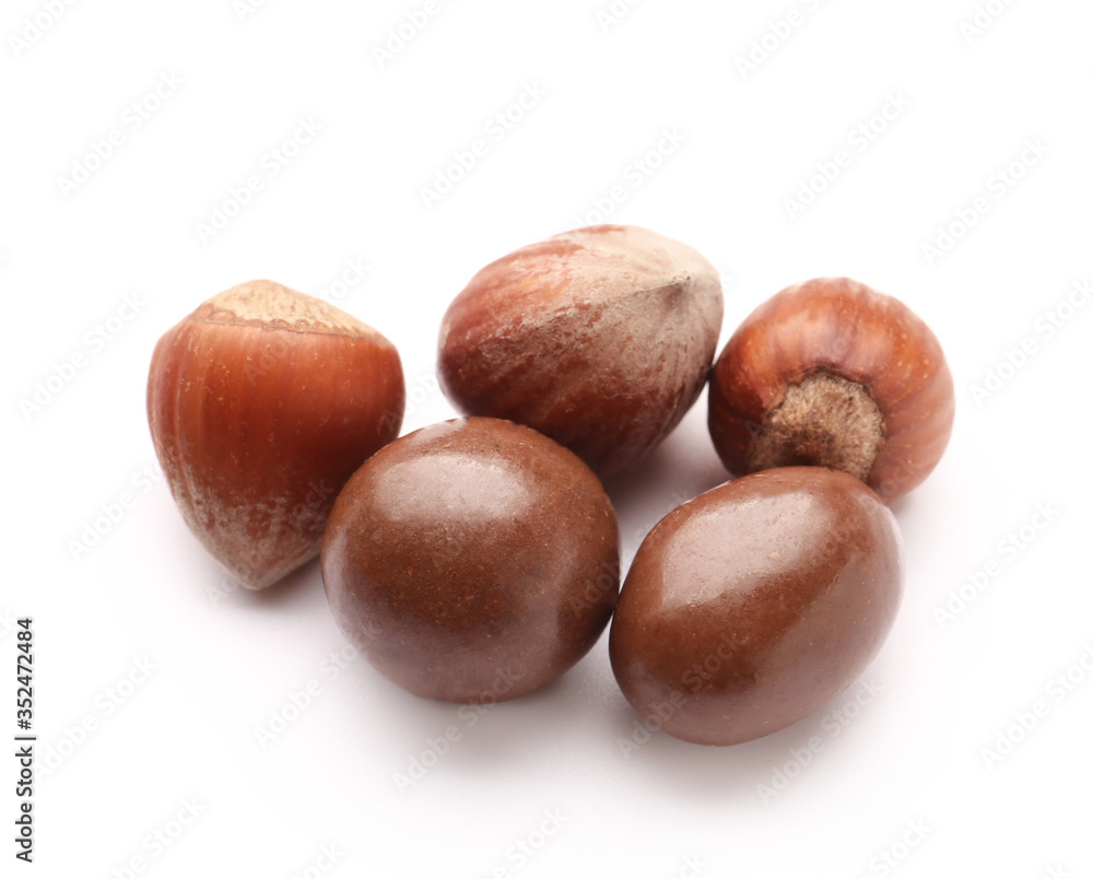 Tasty chocolate nuts on white background