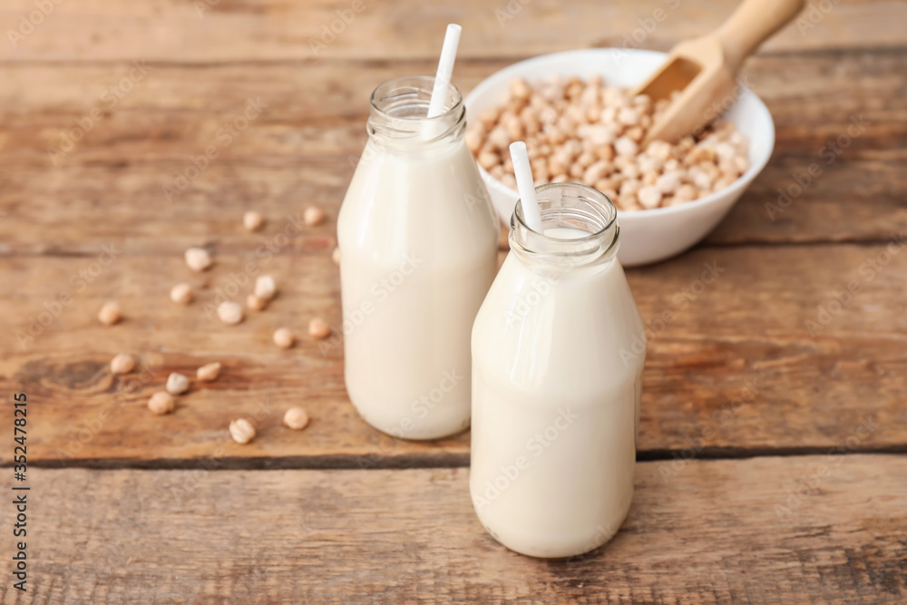 Bottles of tasty chickpea milk on table