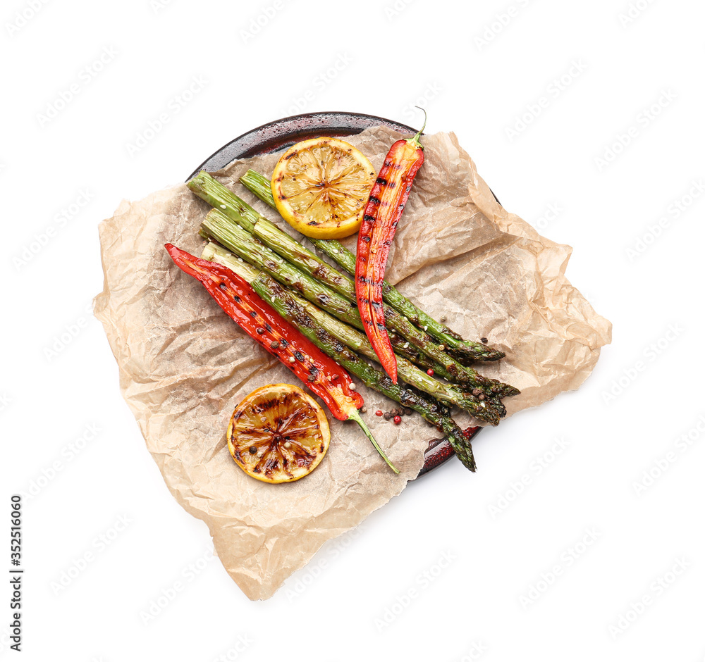 Cooked asparagus with chili pepper and lemon on white background