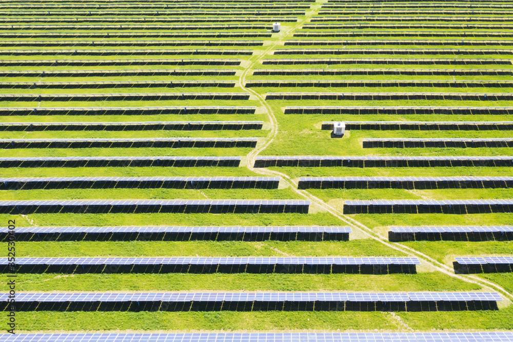 Solar panel from above. Aerial drone photo looking down on rows of blue solar panels in a renewable 