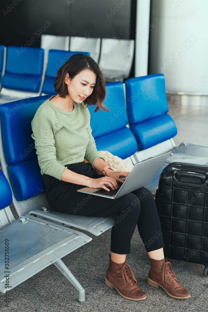 Young woman using laptop at the airport