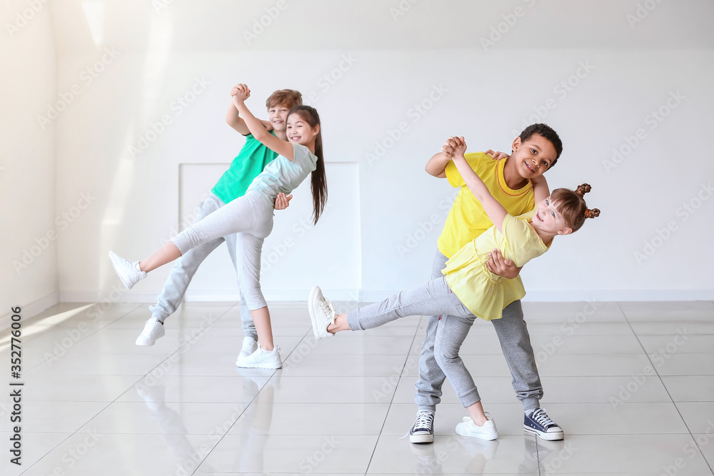 Cute little children dancing in studio