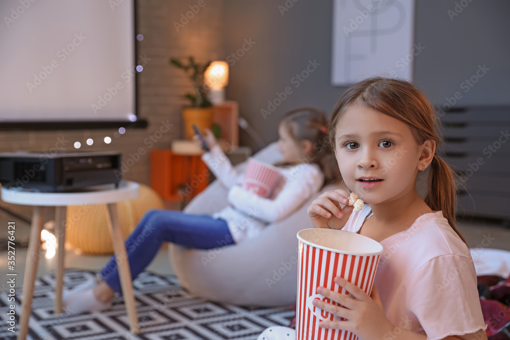 Little girl watching movie at home