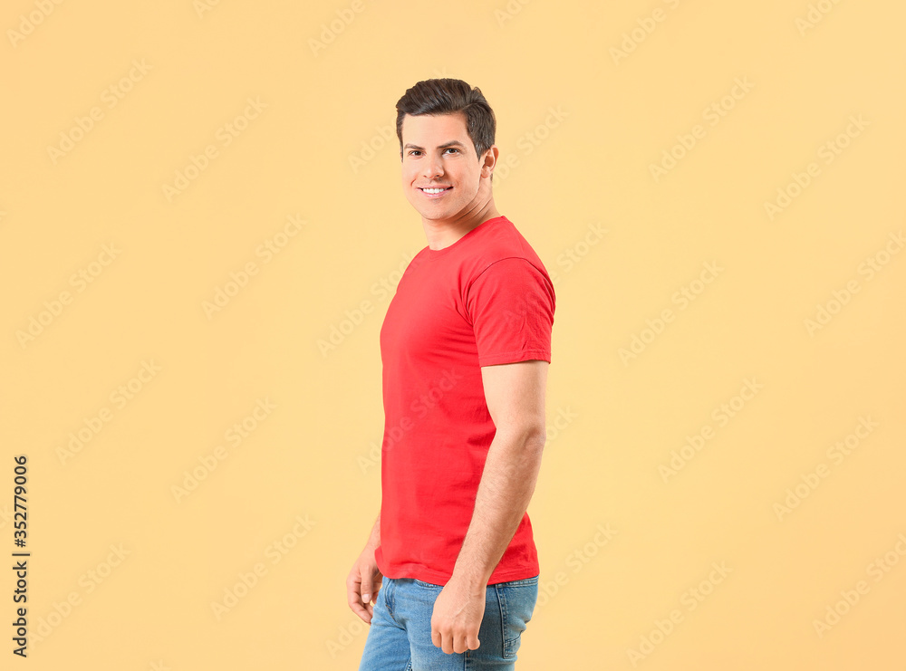 Man in stylish t-shirt on color background