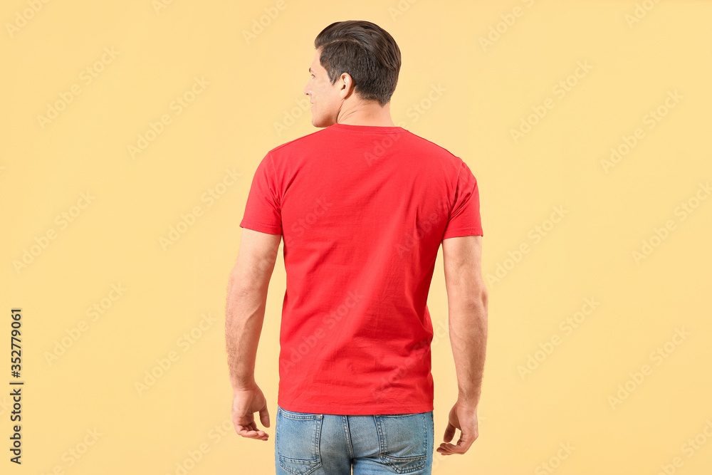 Man in stylish t-shirt on color background