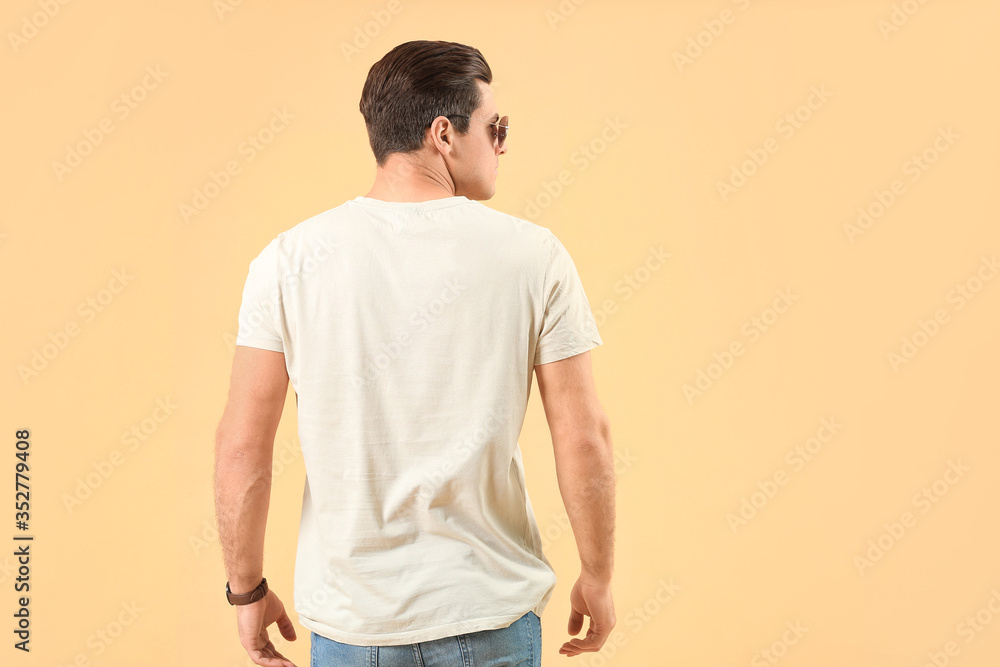 Man in stylish t-shirt on color background