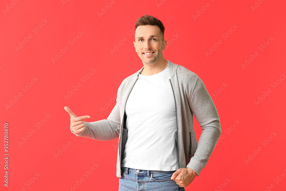 Man in stylish t-shirt on color background