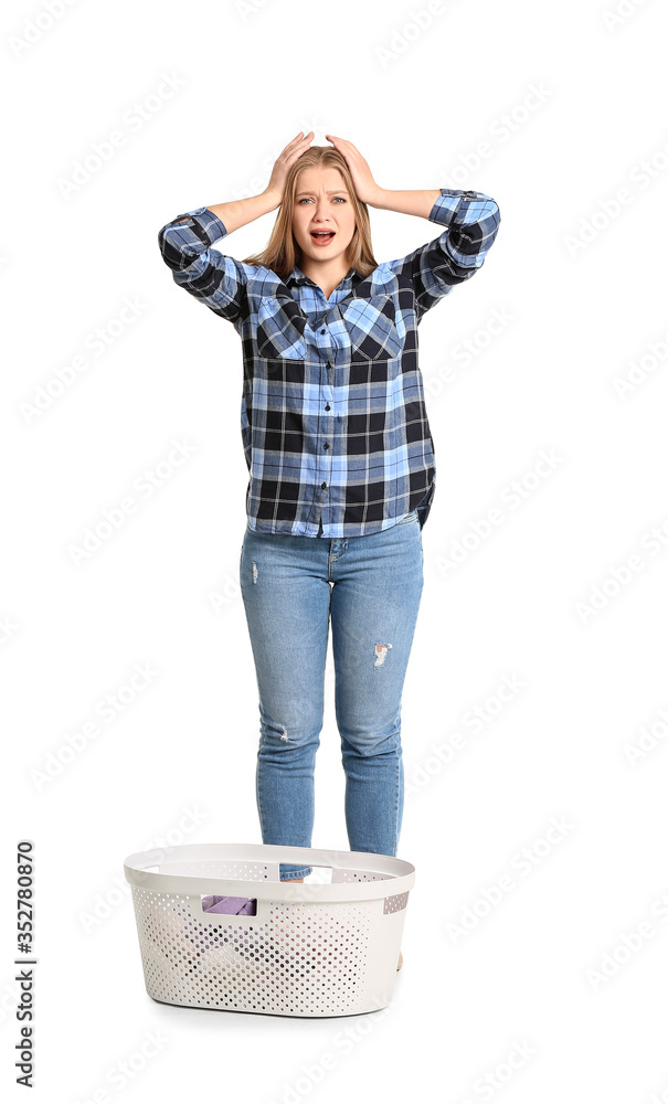 Troubled woman with laundry on white background