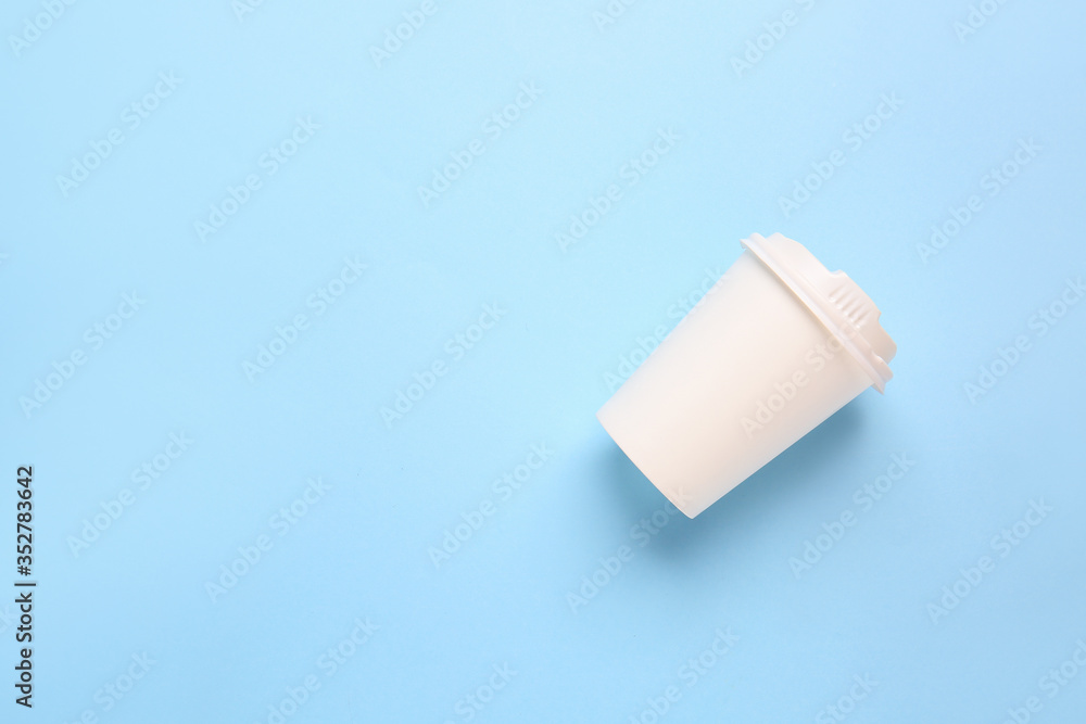 Takeaway cup for drink on color background