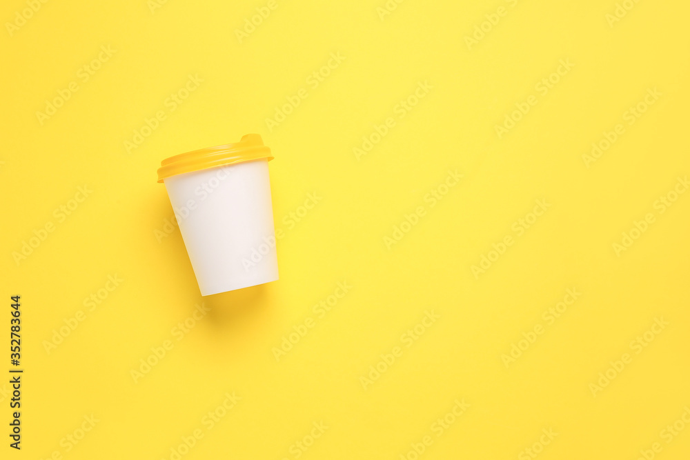 Takeaway cup for drink on color background