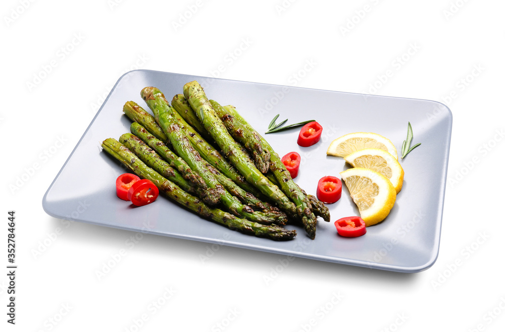 Cooked asparagus with chili pepper and lemon on white background