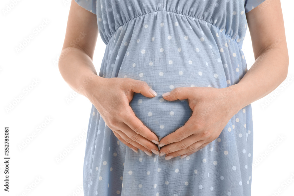 Beautiful pregnant woman making heart with her hands on white background