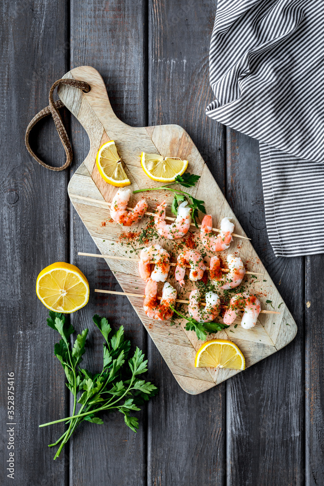 Shrimp skewers - appetizer in mediterranean kitchen - on wooden table top view