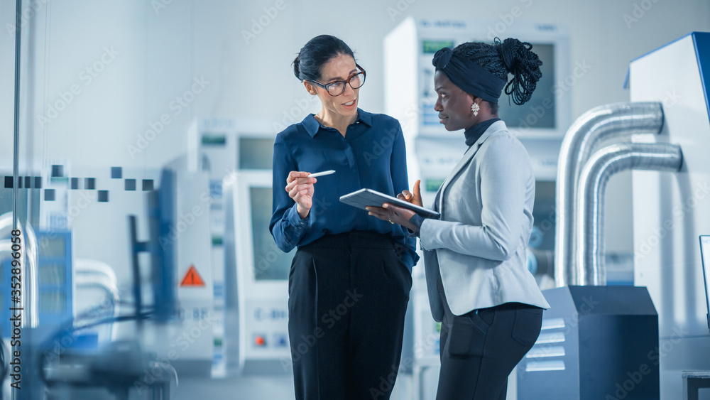 Industrial Engineer Talks with Project Supervisor, They Use Digital Tablet Computer and Discuss Mode