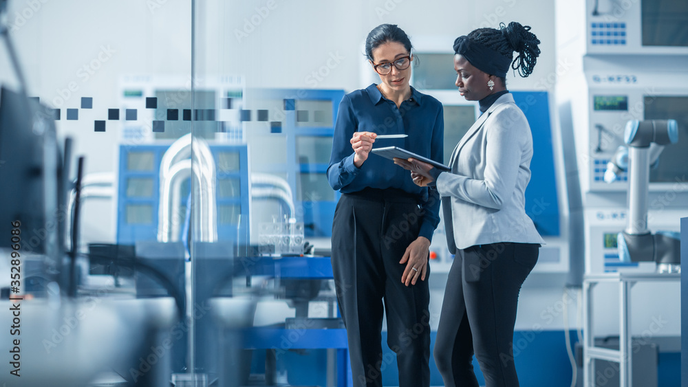 Industrial Engineer Talks with Project Supervisor, They Use Digital Tablet Computer and Discuss Mode