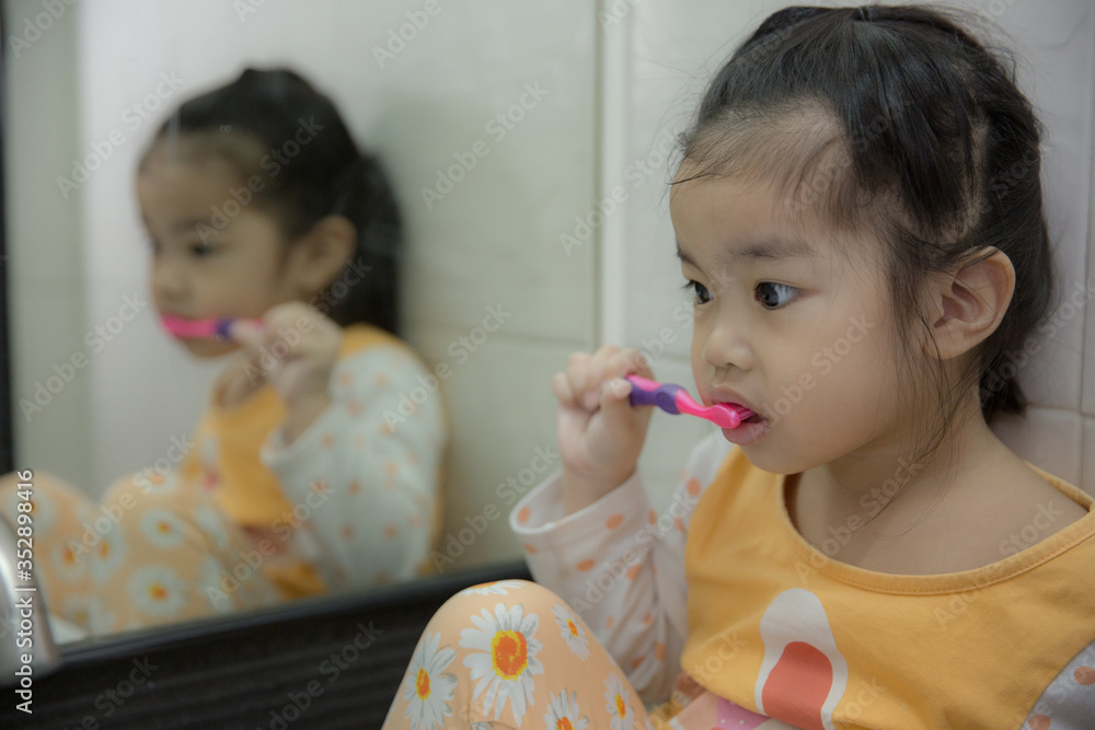 Little asian cute girl brush teeth