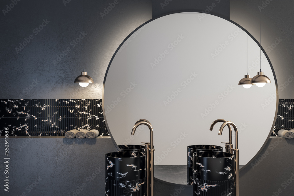 Cozy black marble bathroom with round mirror