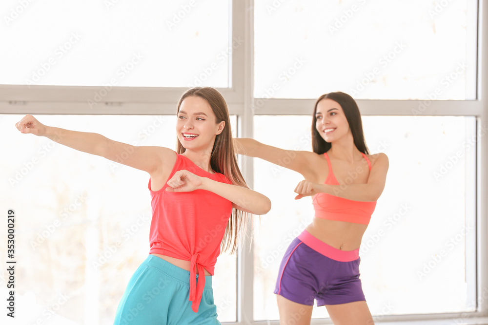 Beautiful young women dancing in studio