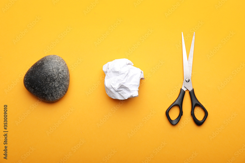 Scissors, rock and paper on color background