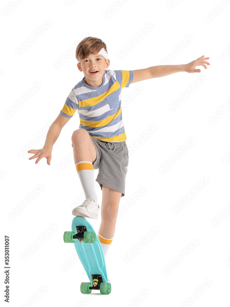 Sporty little boy with skateboard on white background