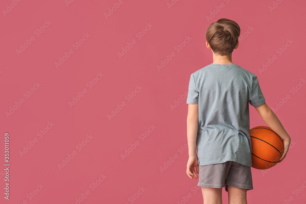 Cute little basketball player on color background