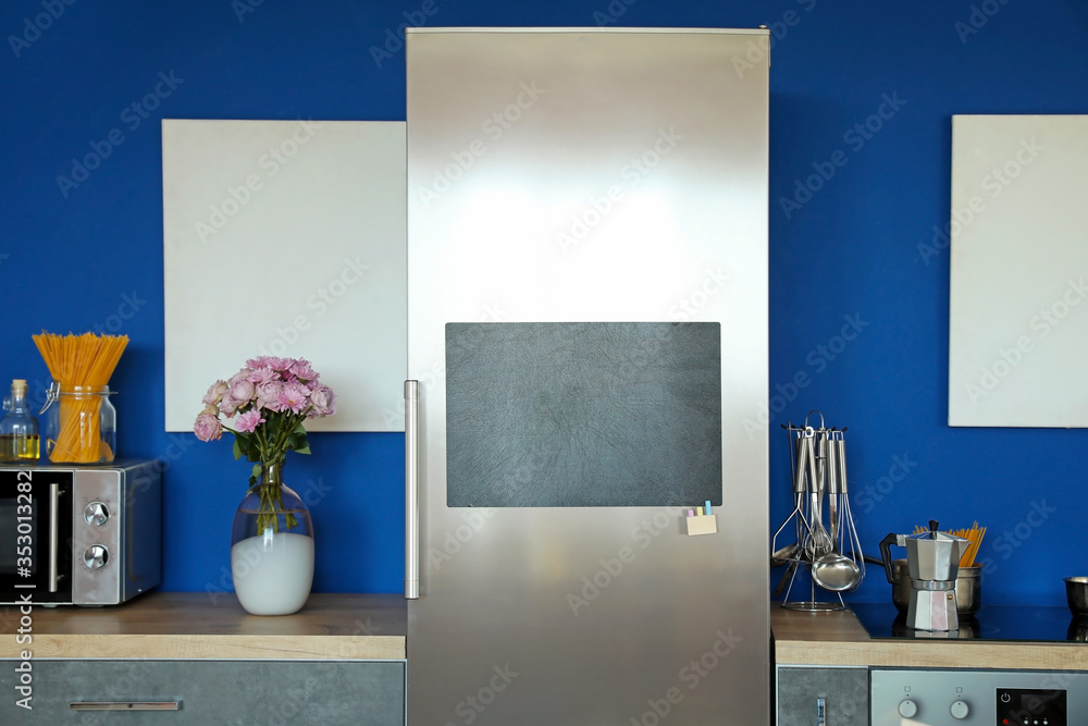 Chalkboard on door of refrigerator in kitchen