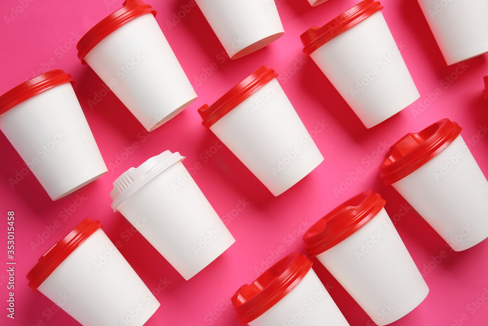 Takeaway cups for drink on color background