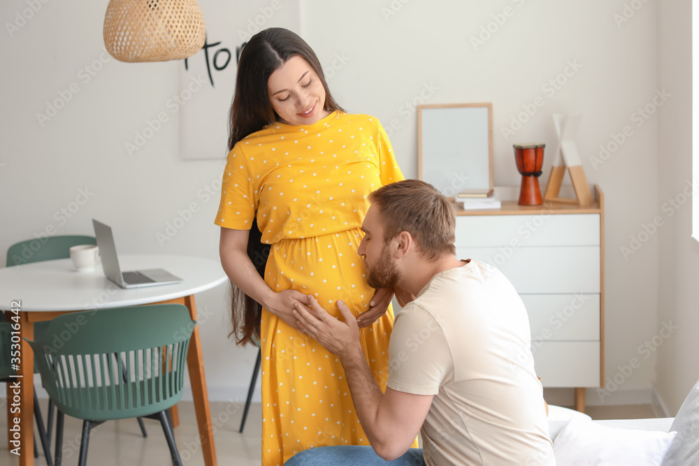 Beautiful pregnant woman with her husband at home