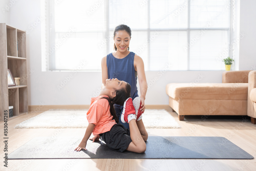 Asian mother and daughter Exercising at home They are doing yoga