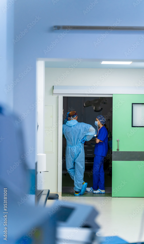 Medical staff having discussion in modern hospital corridor