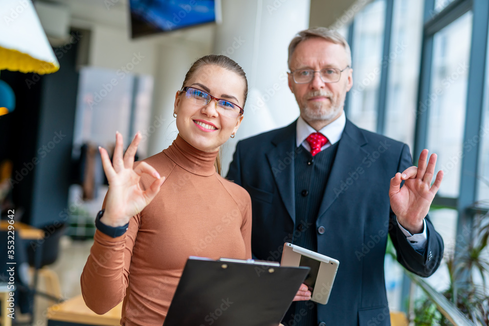 Senior businessman discussing business ideas with the assistance. Mature man and businesswoman in an