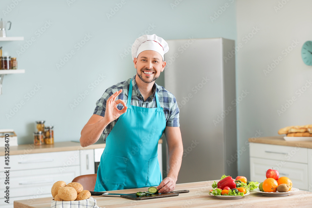 Handsome chef cooking in kitchen