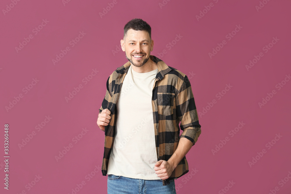 Man in stylish t-shirt on color background