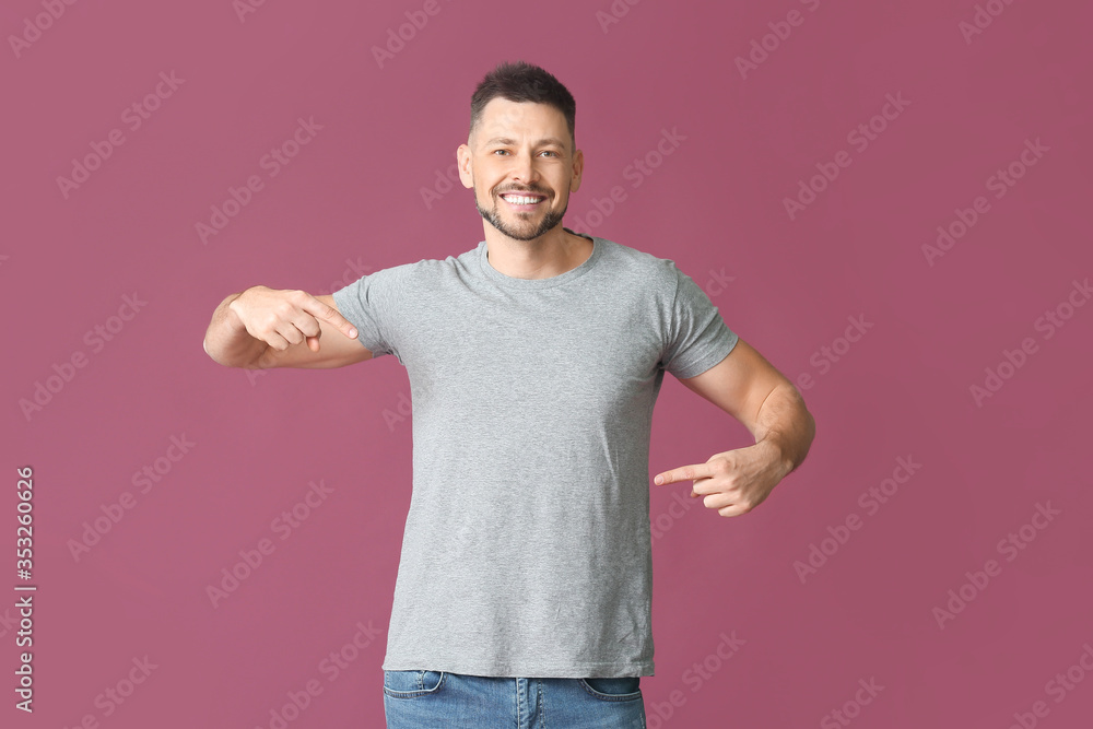 Man in stylish t-shirt on color background