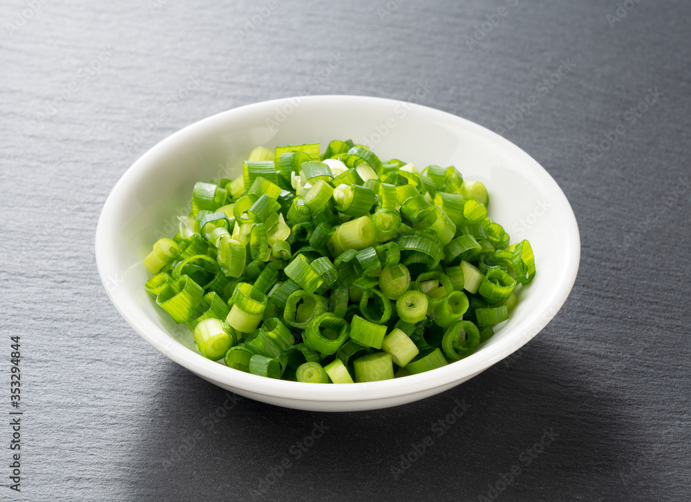 Carved green onions placed on a black background