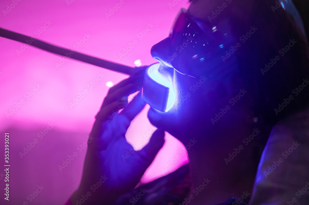 Teeth whitening procedure with ultraviolet light UV lamp