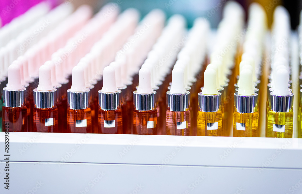 Set of cosmetic bottles in rows, equipment for beauty store