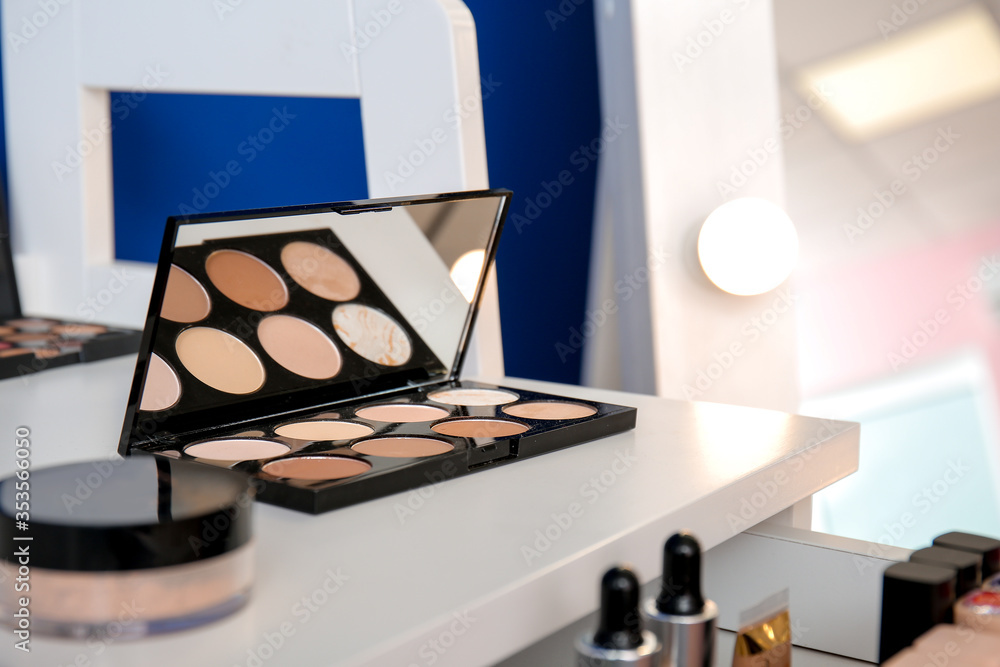 Table with makeup cosmetics in modern dressing room, closeup