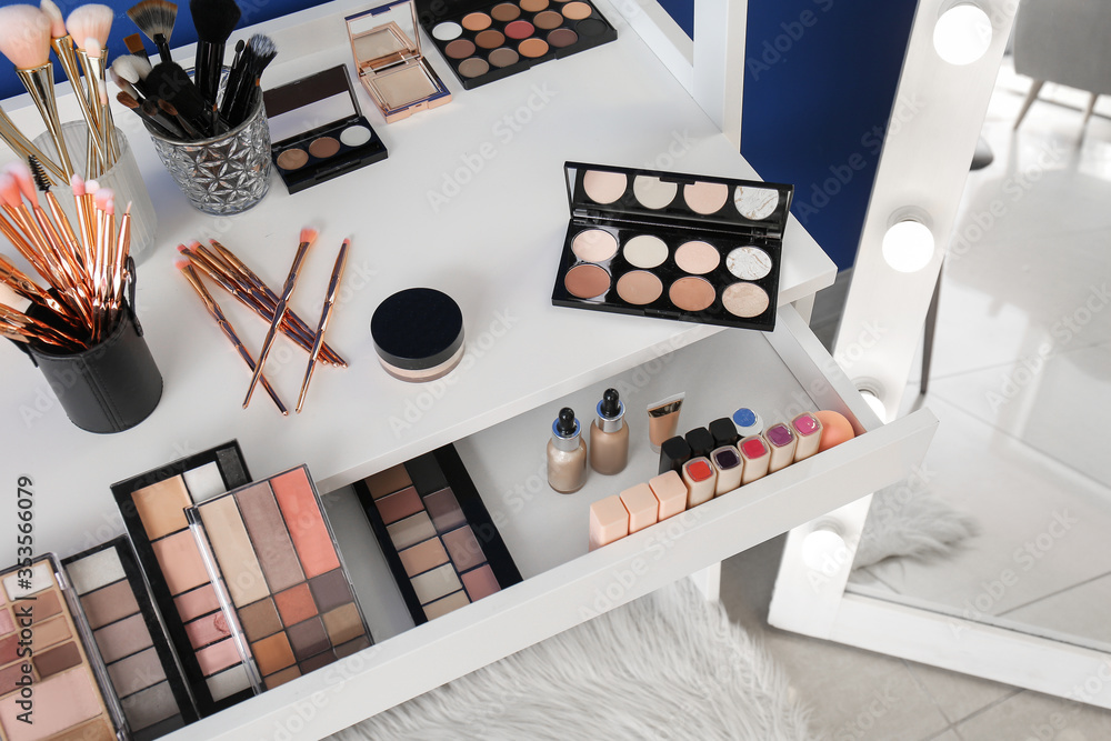 Table with makeup cosmetics in modern dressing room